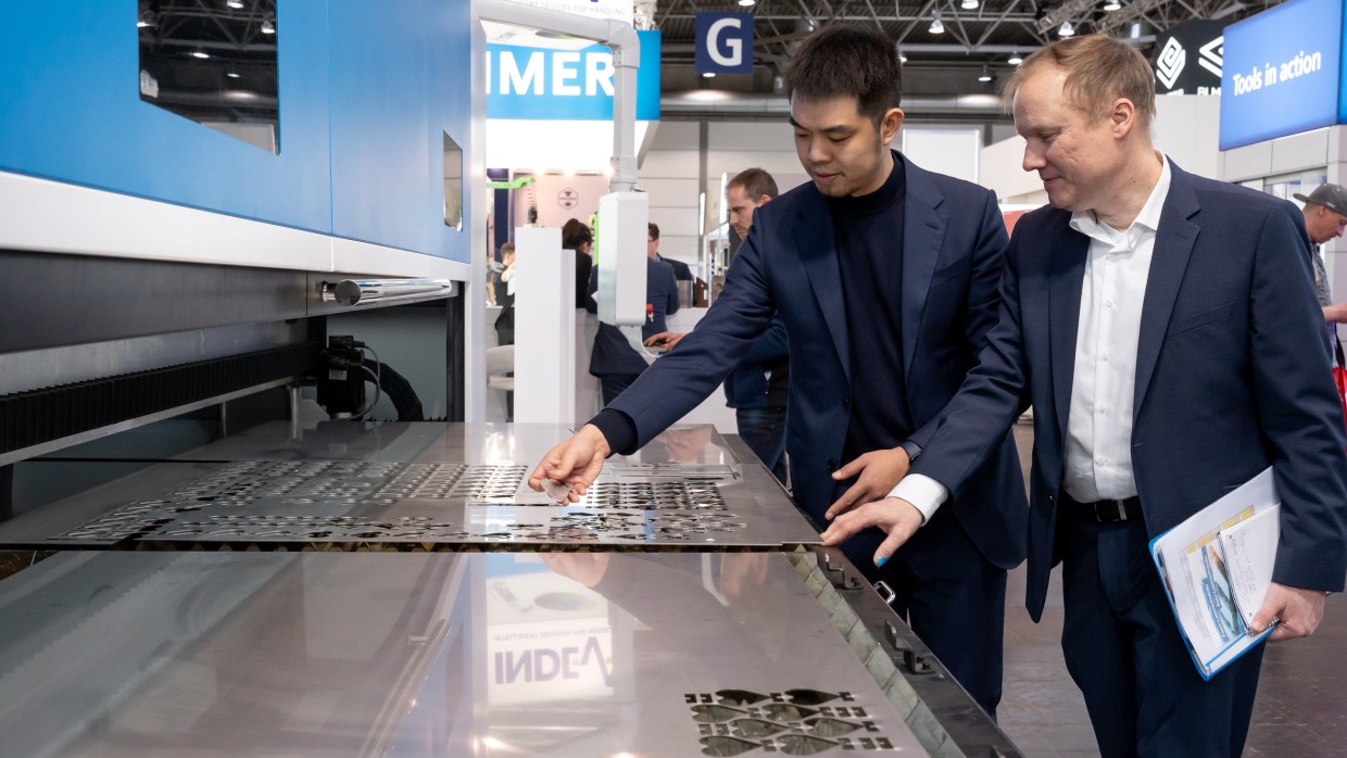 zwei Personen probieren eine Maschine aus, Messeimpressionen Intec - Internationale Fachmesse für Werkzeugmaschinen, Fertigungs- und Automatisierungstechnik